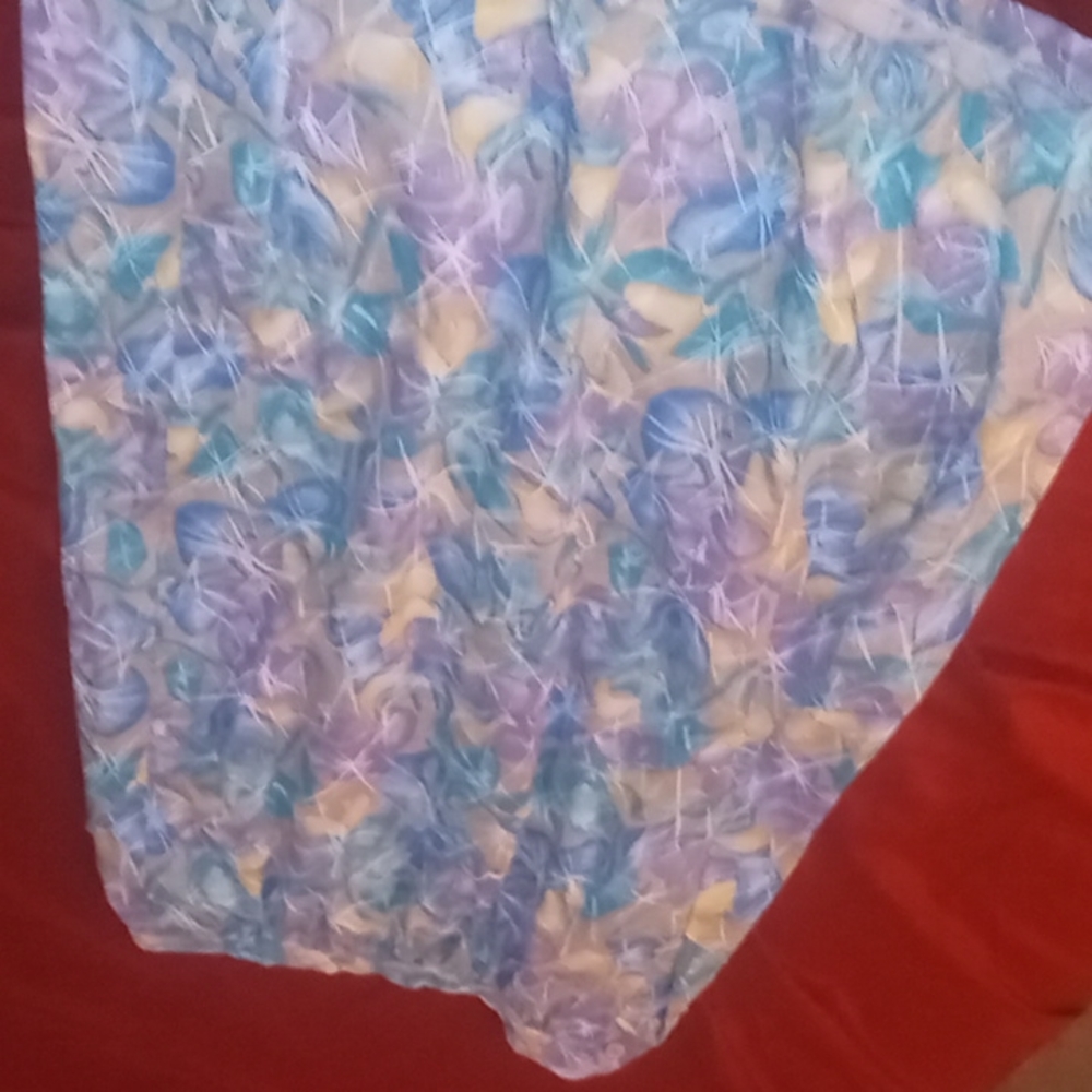 A floral shirt with buttons on the sides including a pocket